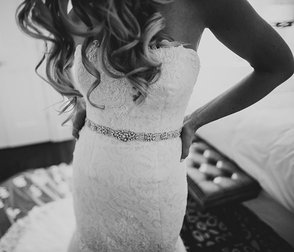 Zdjęcie panny młodej przymierza suknię ślubną w Bridal Reflections