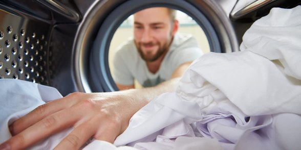 Foto von einem Mann beim Wäsche waschen